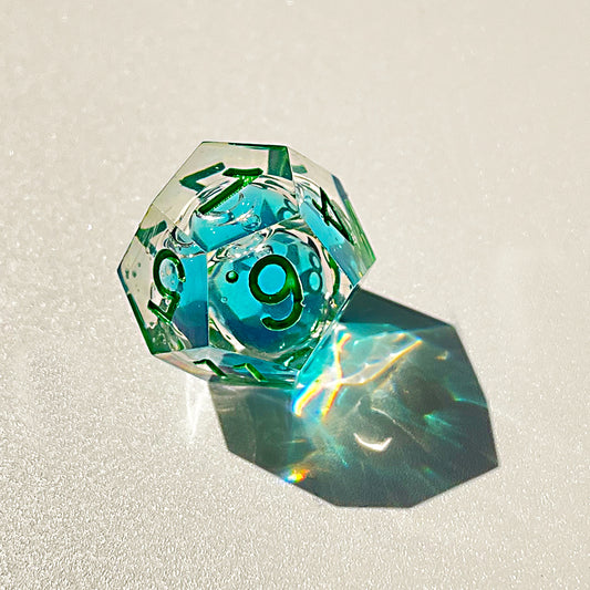 Blue liquid core dnd resin dice with green font for games