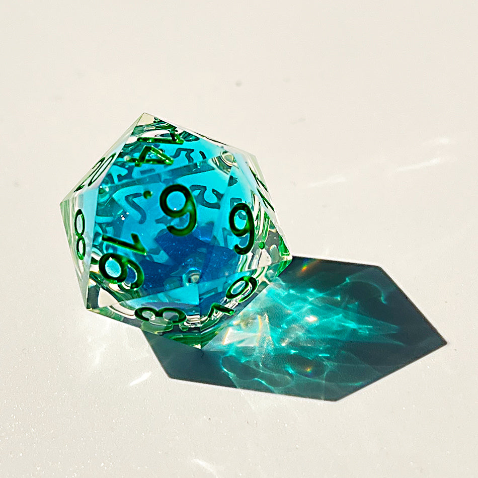 Blue liquid core dnd resin dice with green font for games