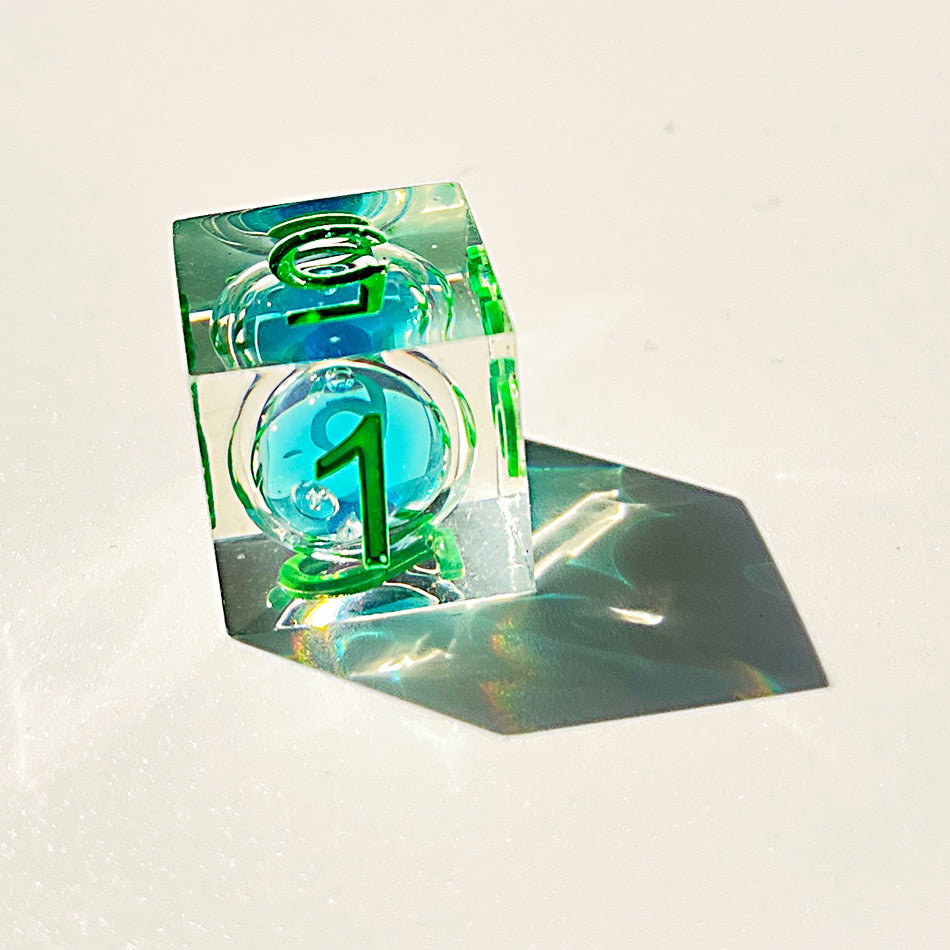 Blue liquid core dnd resin dice with green font for games