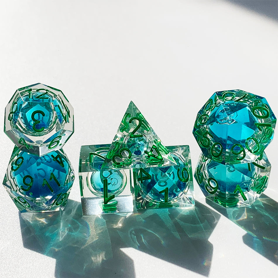 Blue liquid core dnd resin dice with green font for games